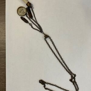 Long chain with hanging charms.